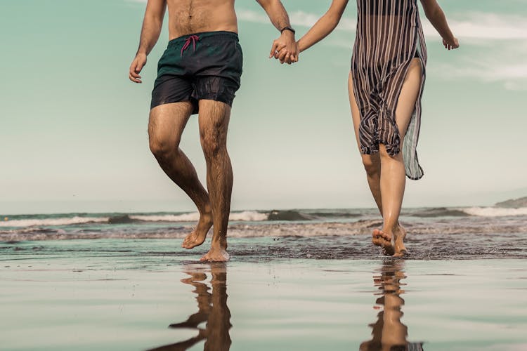 Couple Walking On The Beach