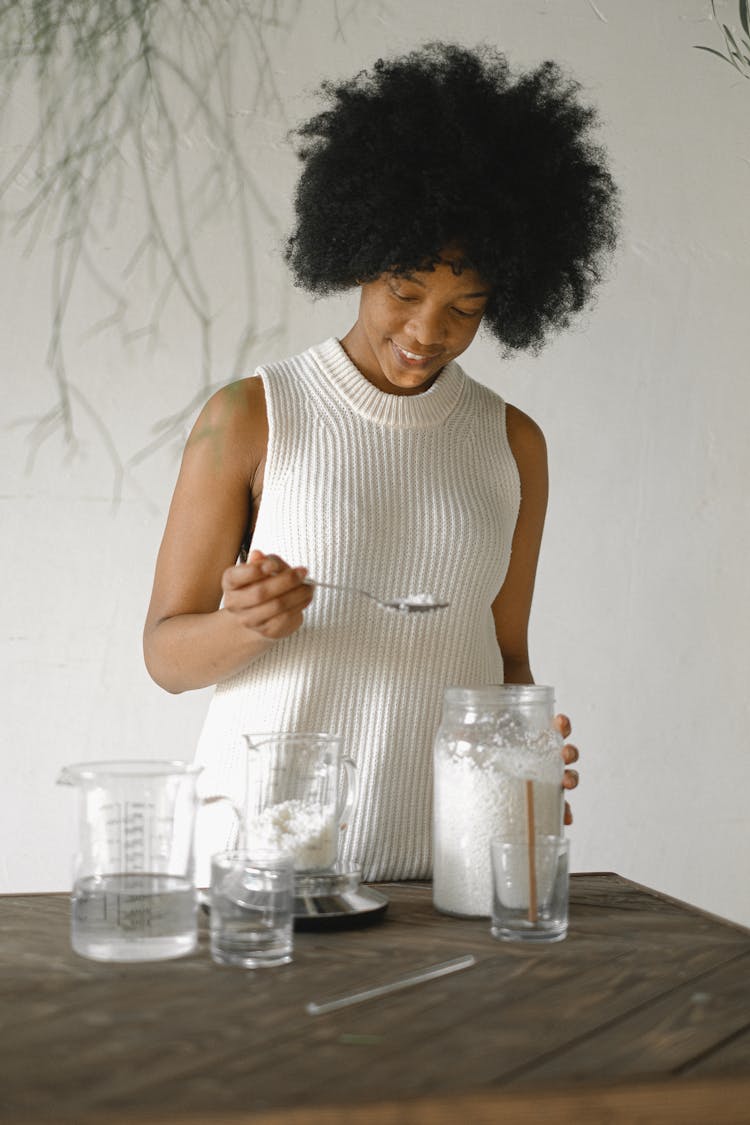 Cheerful Black Woman With Wax Pellets