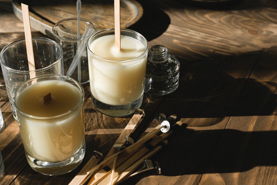 Hand-poured candles with wooden wicks on a workshop bench — Anna Shvets on Pexels