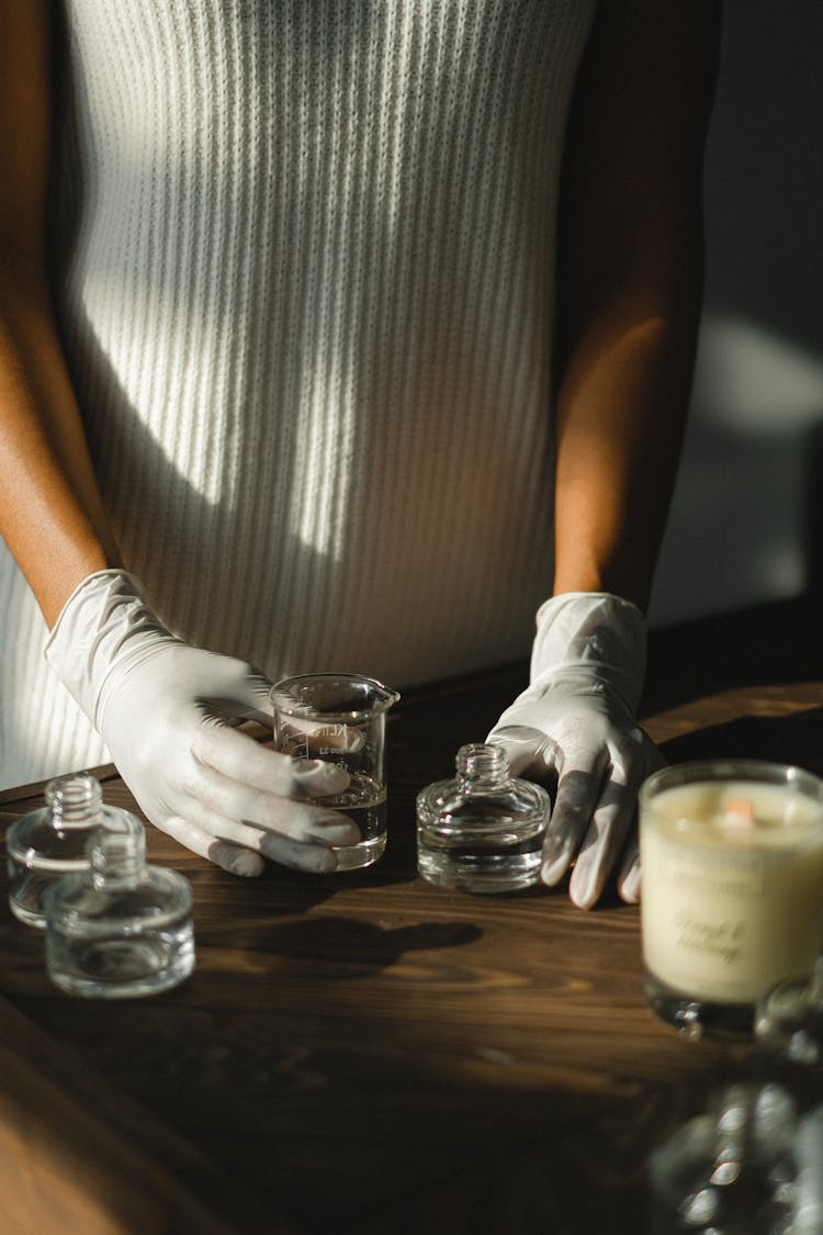 Black Woman In Latex Gloves Making Aromatic Diffuser