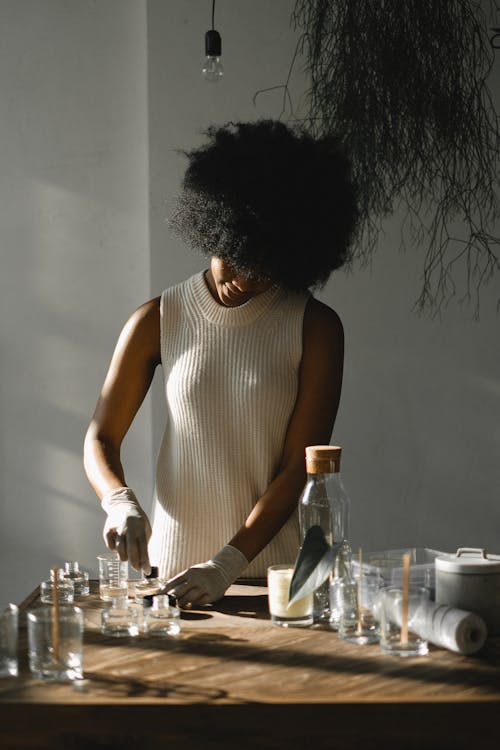 Free Black woman making liquid incense in workshop Stock Photo
