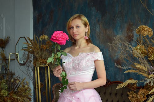 Smiling young bride with pink flower