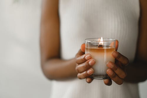 Free Crop black woman with burning candle Stock Photo