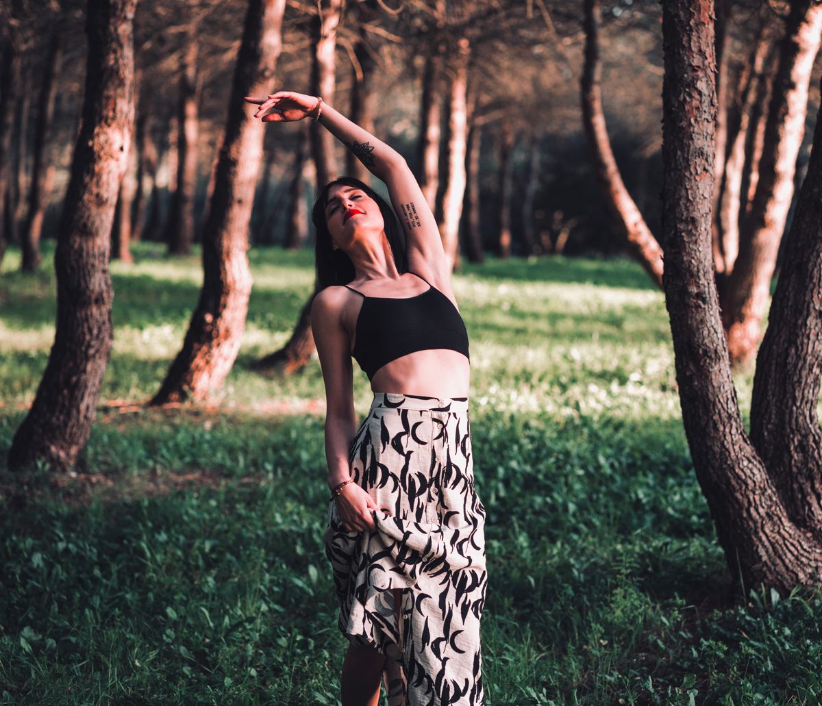 Woman relaxing in a sunlit forest