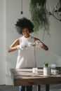 Content black woman making handmade candles in workshop