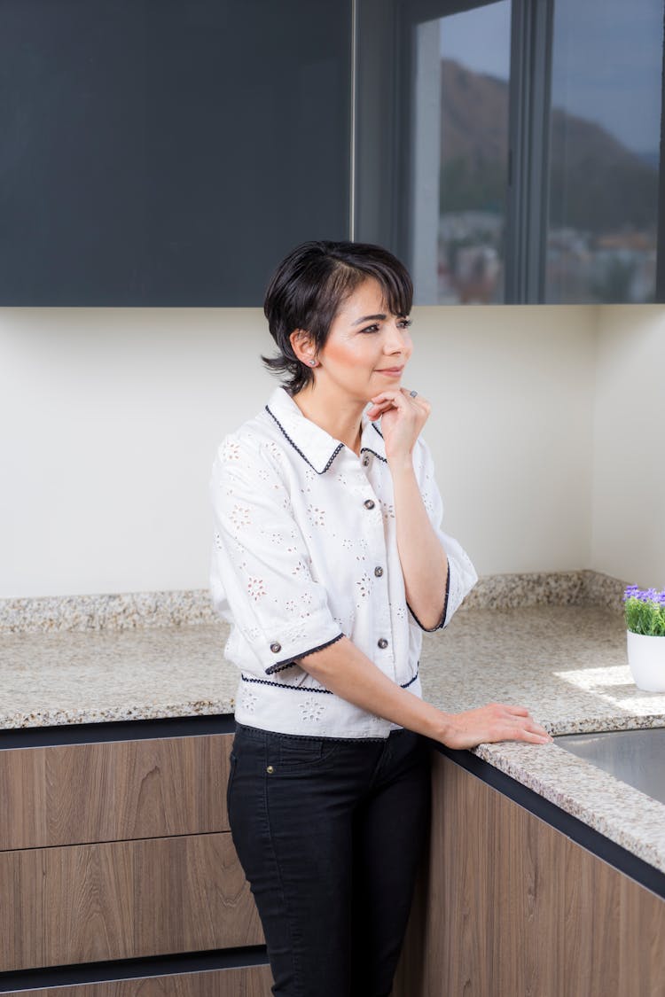 A Woman Standing In The Kitchen