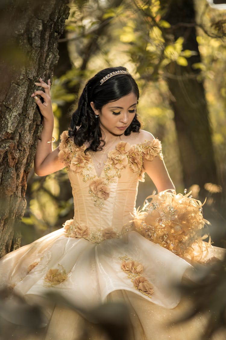 Woman In Yellow Gown Standing Near Tree