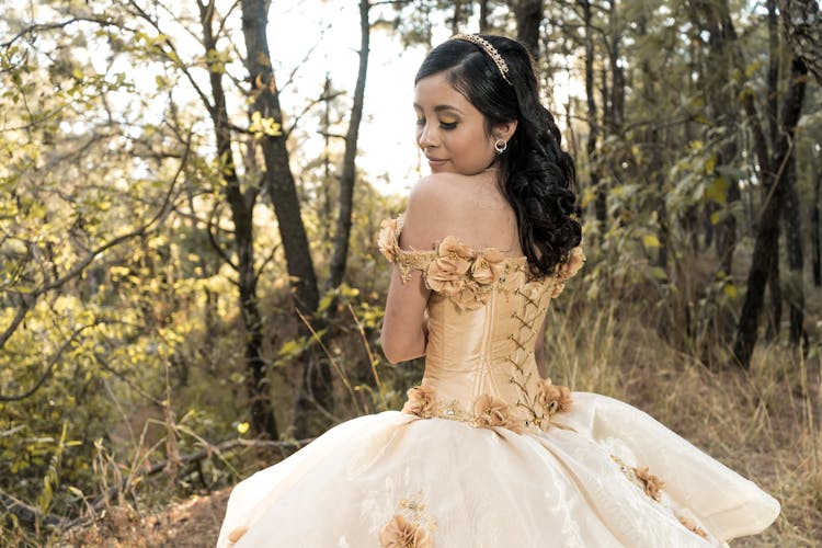 Back View Of Woman In Yellow Gown Standing