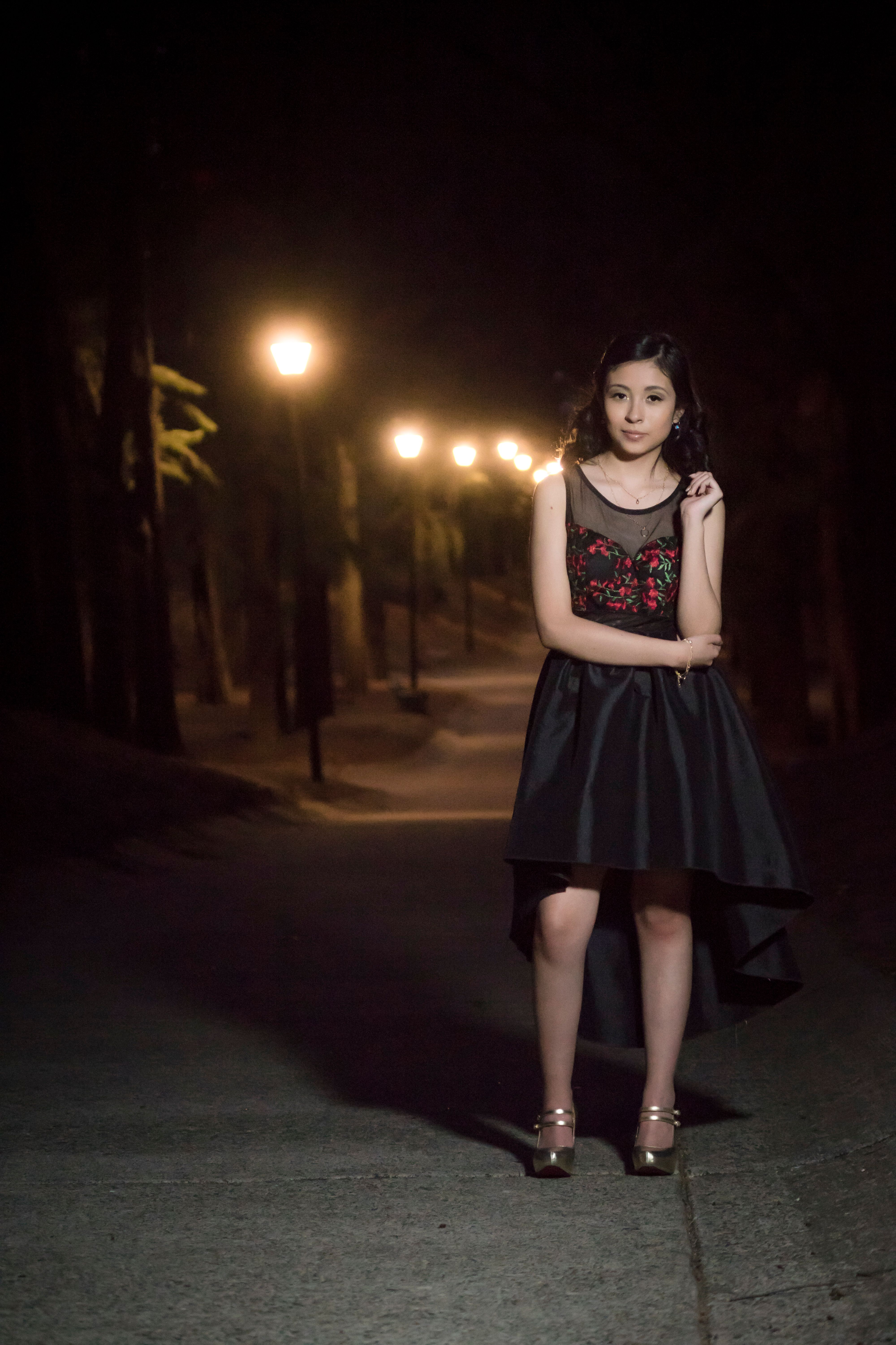 Photo Of Female in Black Dress Standing On The Street · Free Stock Photo