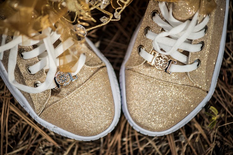 Close Up Photo Of Gold Sneakers