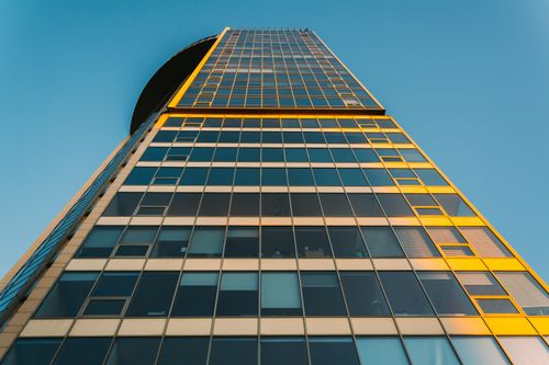 Free Low angle view of a glass skyscraper in St. Petersburg, highlighting modern architecture against a clear blue sky. Stock Photo