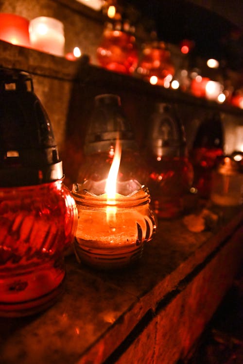 Lighted Candle in Clear Glass Jar