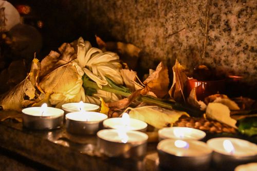 Free A serene arrangement of tealights, dried leaves, and flowers creating a warm ambiance. Stock Photo