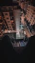 Man sitting on edge of building and observing night city