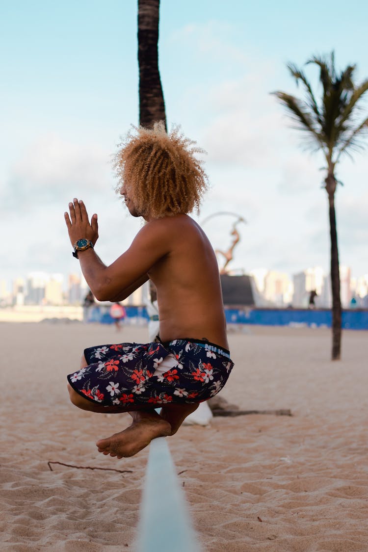 Man In Yoga Pose On Beach