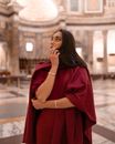 Pensive attractive woman standing in pompous gallery