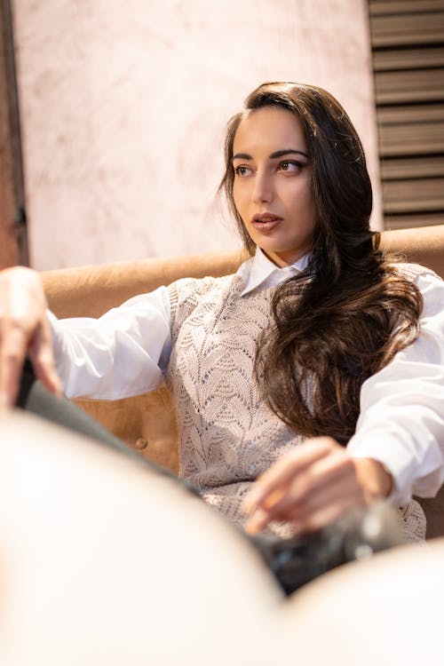 Attractive woman sitting on cozy couch