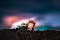 Machinery Digging Ground during Northern Lights