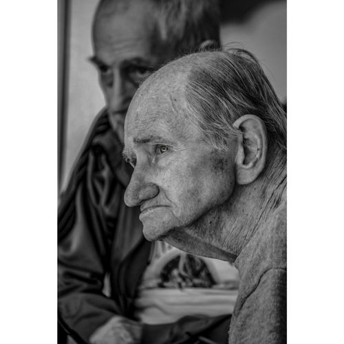 Free Close-up black and white portrait of two senior men reflecting thoughtfully. Stock Photo