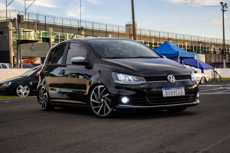 Black Volkswagen Hatchback Turning On The Road