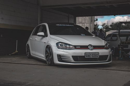 Free White Volkswagen GTI hatchback parked indoors, showcasing sleek design and modern aesthetics. Stock Photo