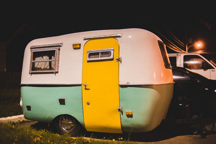 Small Vintage Camping Trailer Parked On Street