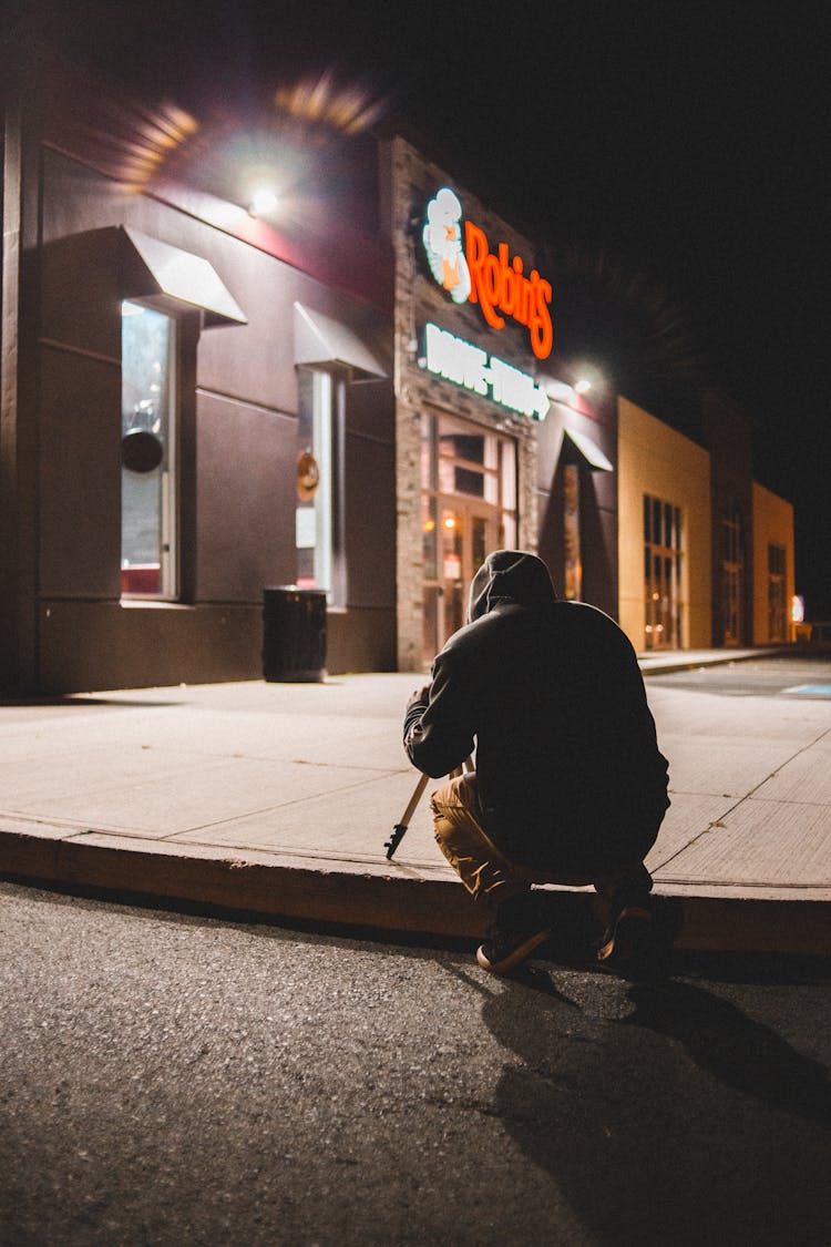 Man Taking Photo Of Building At Night