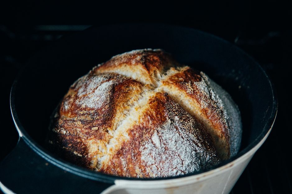 From above of baked homemade crispy bread in baking dish prepared in oven