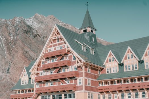 Beautiful alpine-style hotel against a stunning mountain landscape in Waterton, Alberta.