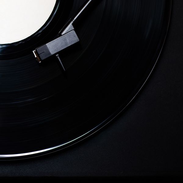 Vinyl record turning on a matte black platter — photo by Miguel A. Padrinan on Pexels