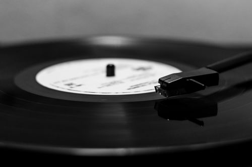 Free Black and white close-up of a vintage vinyl record spinning on a turntable, showcasing classic music nostalgia. Stock Photo