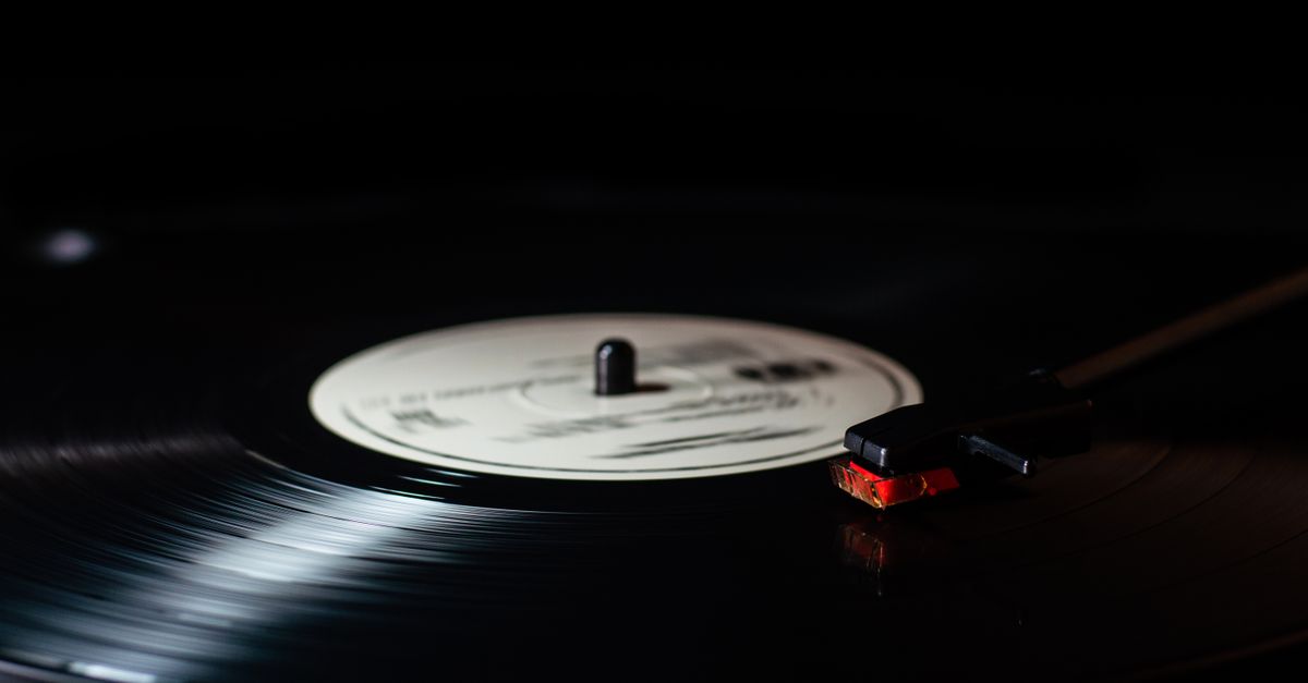 Close-up of a needle dropping onto a spinning vinyl record