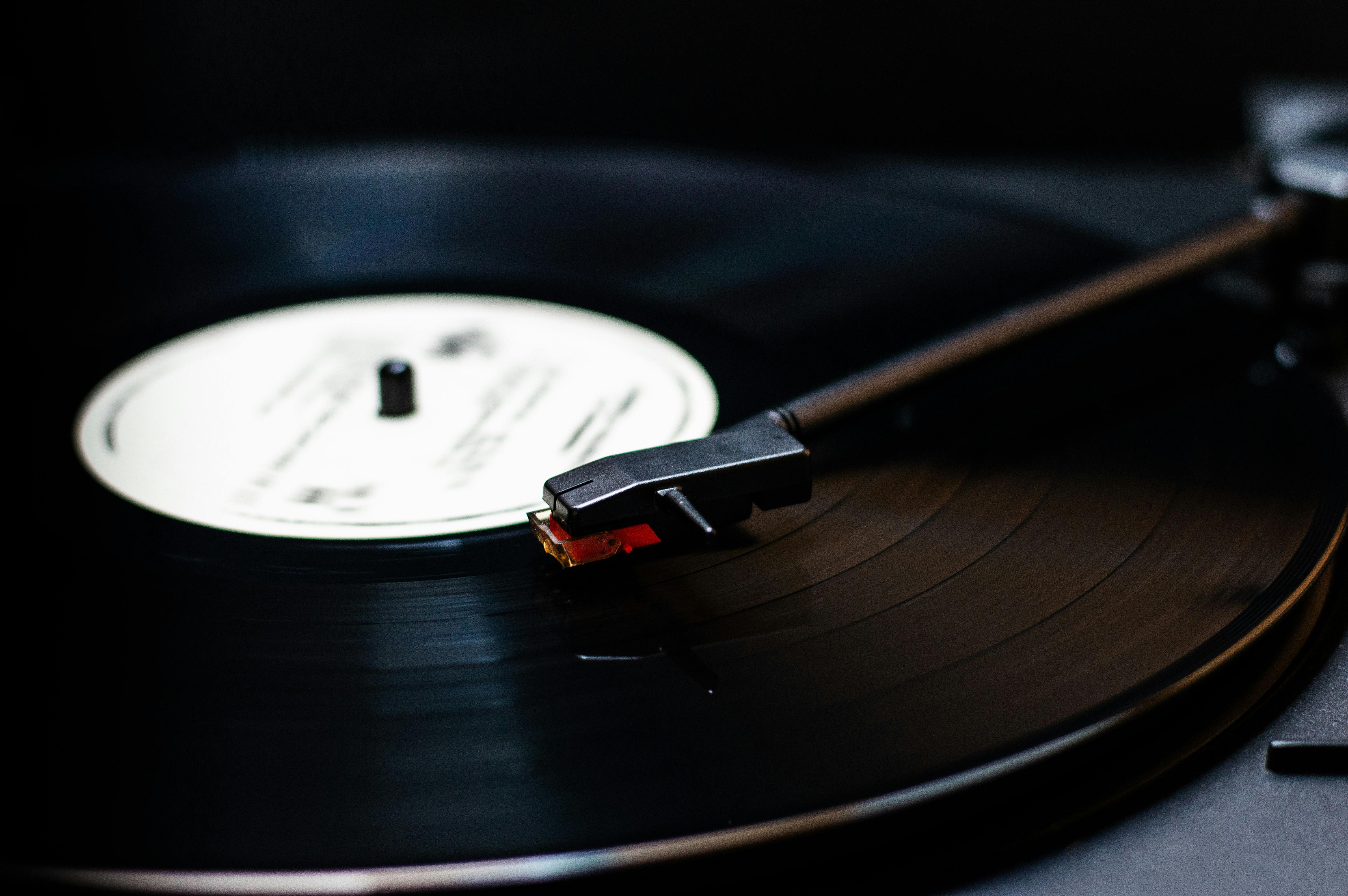 black vinyl record on vinyl record player