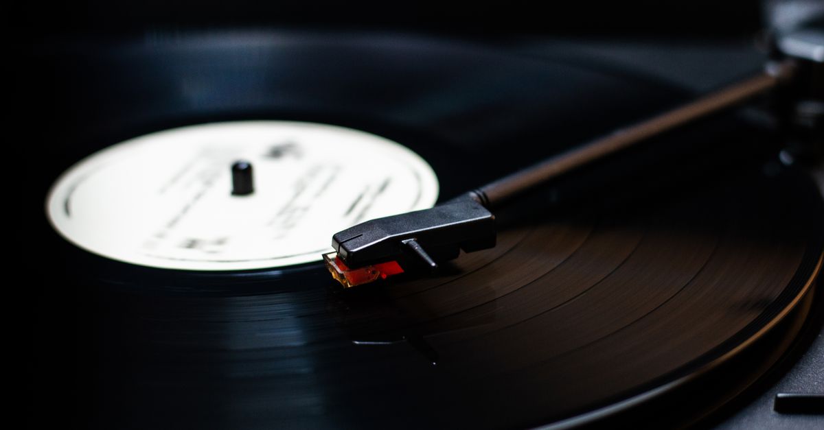 close-up of turntable needle dropping onto spinning vinyl record