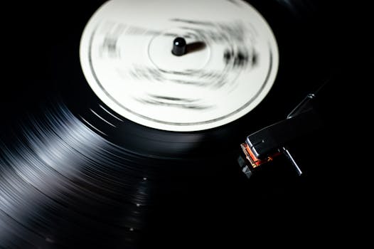 Close-up of a vintage vinyl record spinning on a turntable.