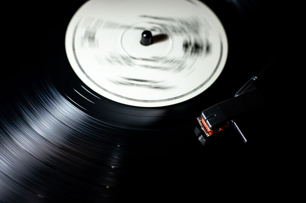 Vinyl record spinning under a turntable needle — photo by Miguel Á. Padriñán on Pexels