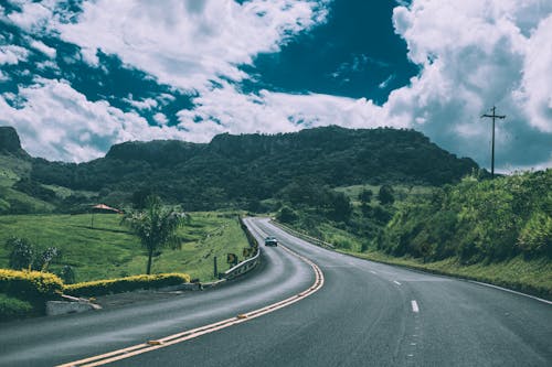 Free Green Vehicle on Concrete Road Stock Photo