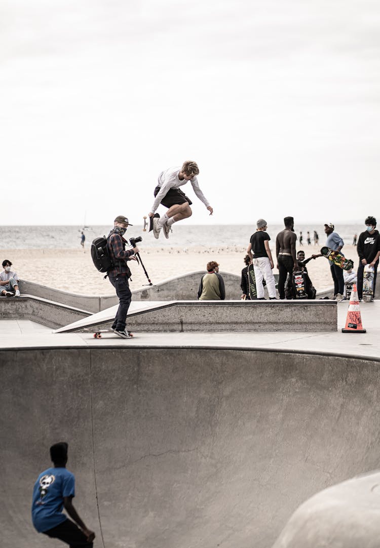 Man Jumping On Skateboard In Skate Park