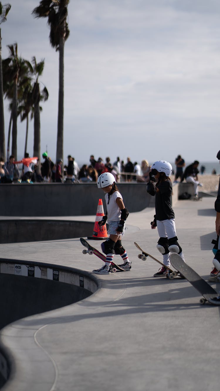 Anonymous Kids With Skateboards In Skate Park