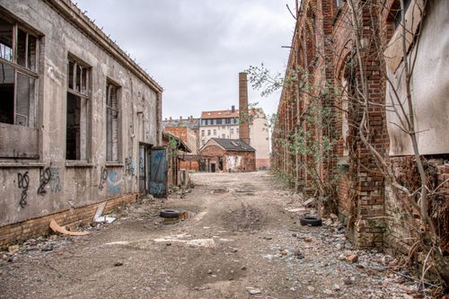 Free Explore the abandoned and overgrown industrial site on a cloudy day in Leipzig. Stock Photo