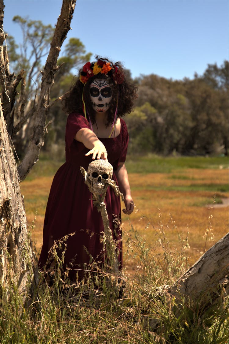 Woman In Red Dress Wearing White Skull Mask