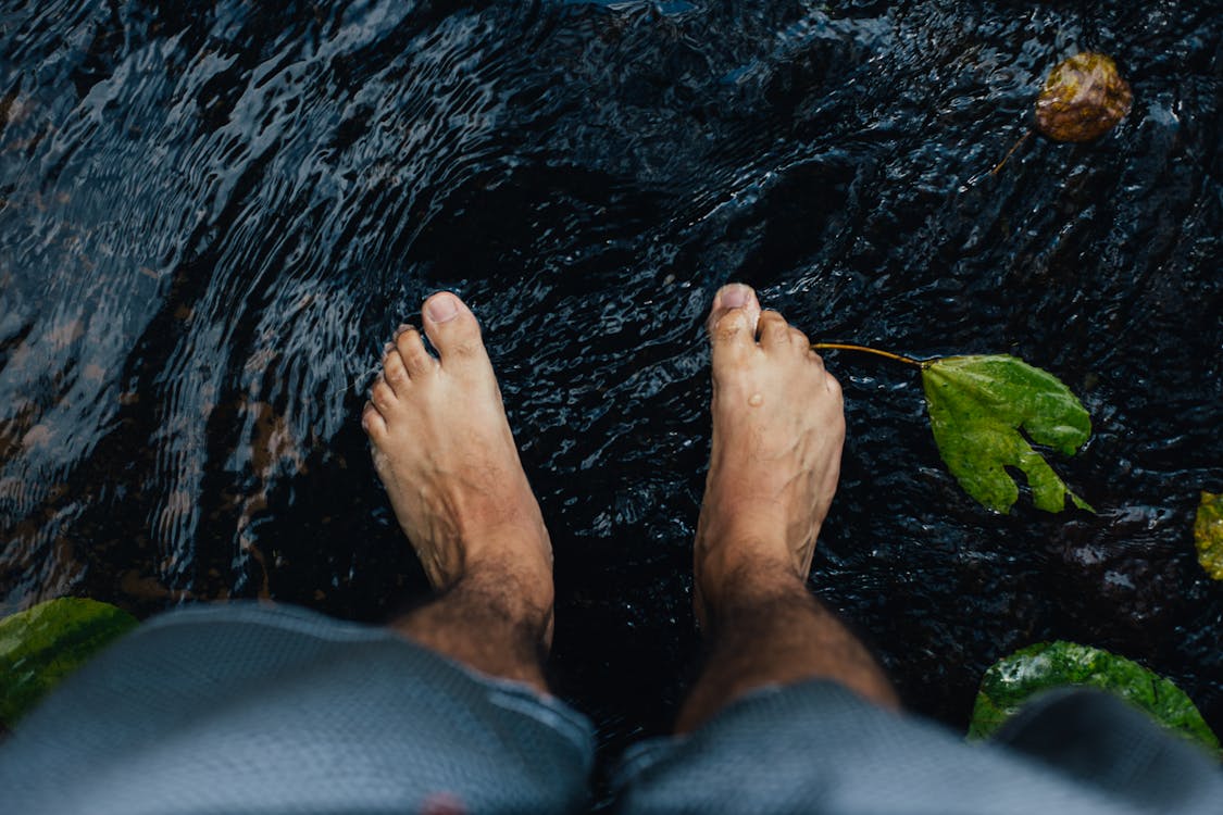 Free Person Foot on Water Stock Photo