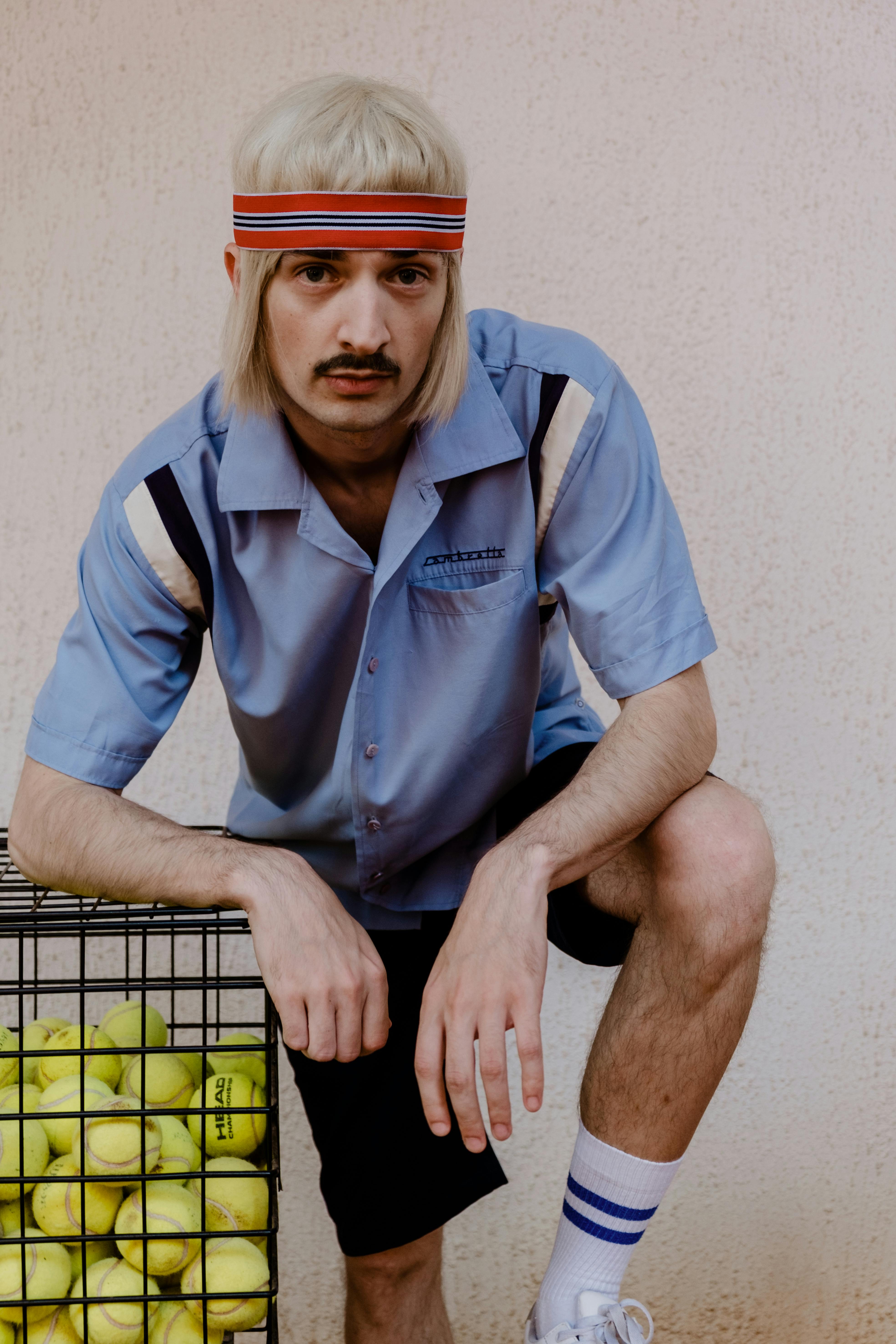 Photograph of a Tennis Player with a Sweatband · Free Stock Photo