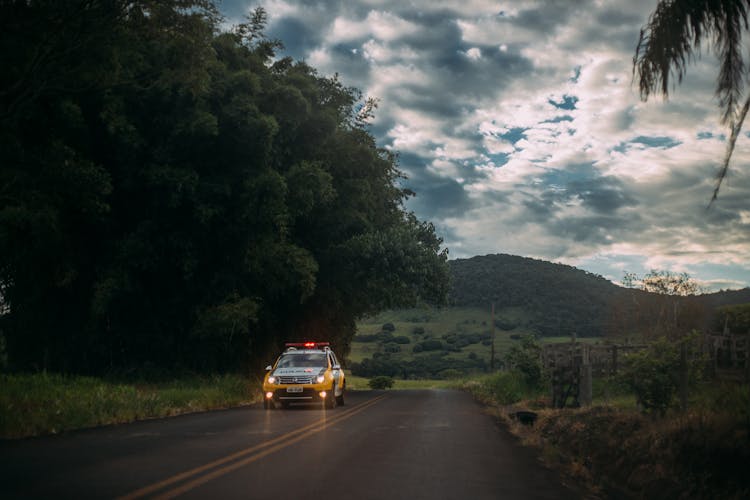 Yellow And White Police Car Lone On The Road