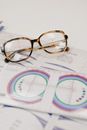 From above of lens ruler with illustration on paper with text and stylish spectacles on white background