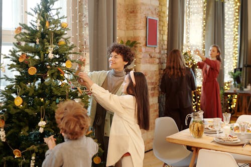 Free Family Decorating a Christmas Tree Stock Photo