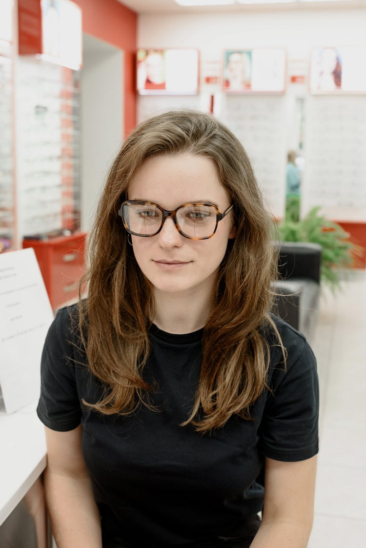 Calm Female Patient In Eyeglasses In Eye Clinic