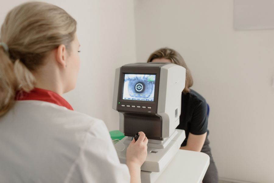 Busy optical retail store counter with customer being attended by staff