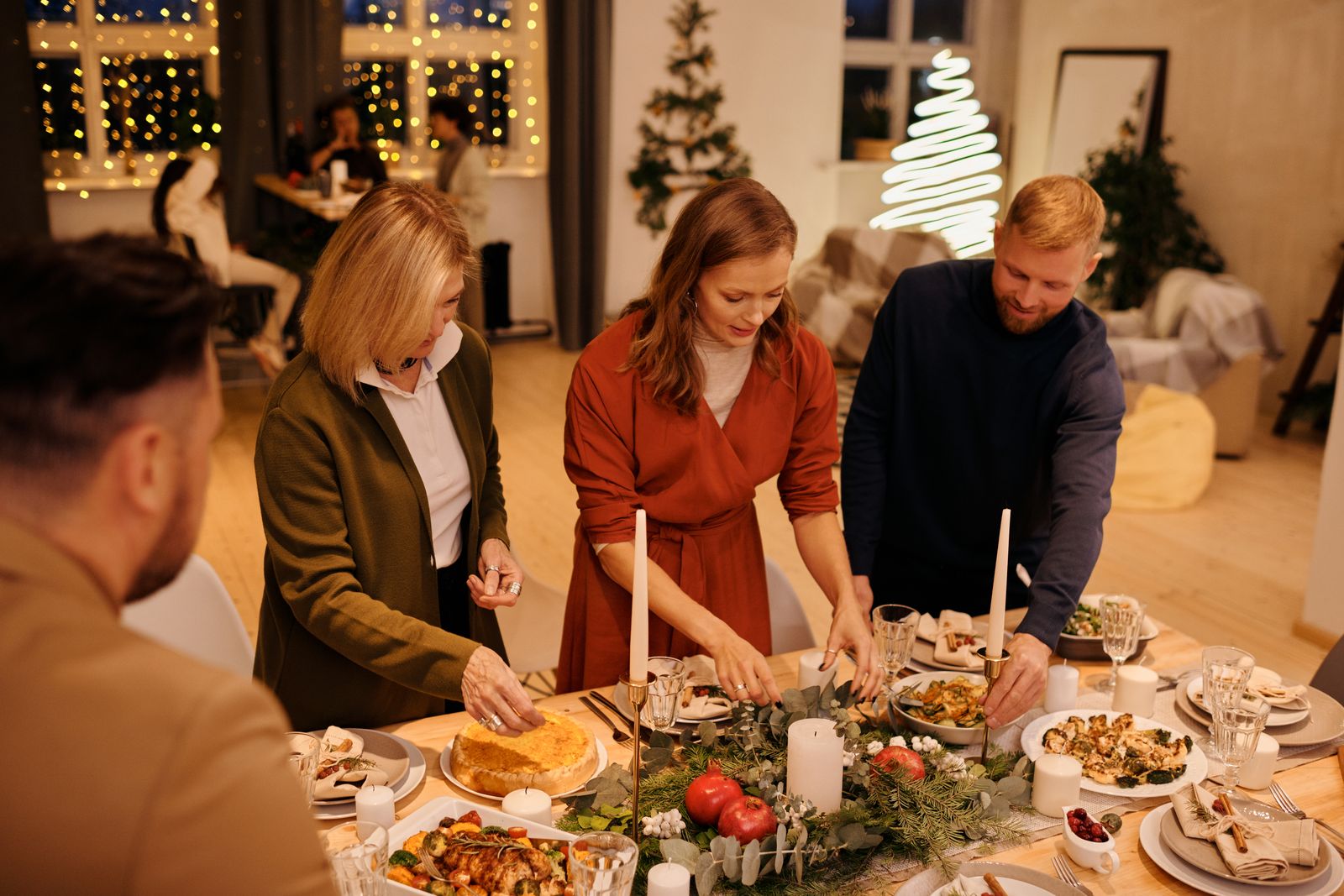 Festive Christmas dinner table prepared with food and place settings.
