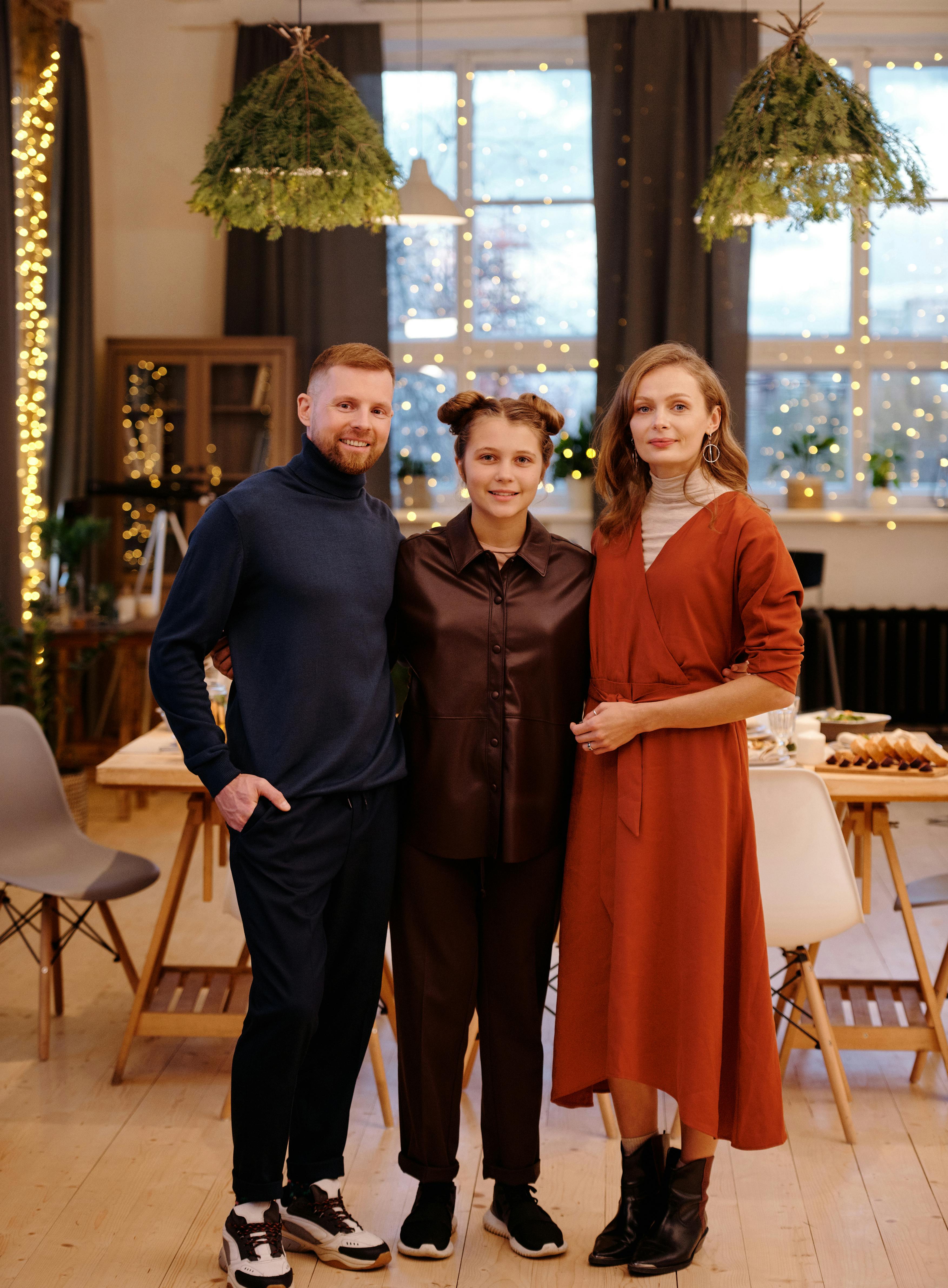 family smiling while looking at the camera